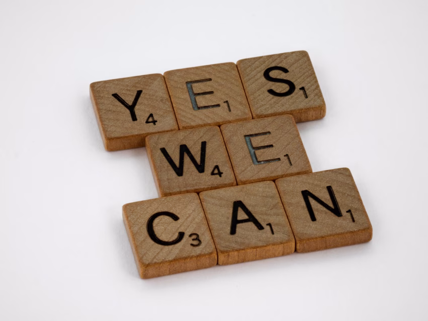 Yes we can, spelt out as Scrabble tiles. Photo by Brett Jordan on Unsplash.com